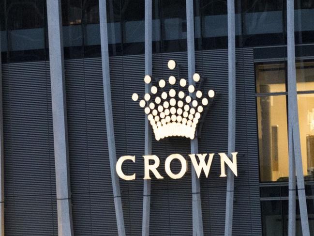 The Crown Resorts Ltd. logo is displayed at the Barangaroo South luxury hotel resort and One Barangaroo Crown residences development in Sydney, Australia, on Tuesday, Oct. 20, 2020. Crown Resorts' stock slumped the most since March on Oct. 19 after the casino operator said it’s being investigated for a potential breach of anti-money laundering and counter-terrorism financing rules. With Crown's annual meeting set for Oct. 22, the probe piles pressure on a company already beset by governance failures. Photographer: Brent Lewin/Bloomberg