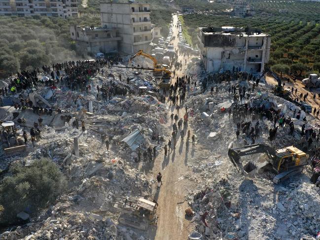 An aerial picture shows rescuers searching the rubble of buildings for casualties and survivors in the village of Besnaya in Syria's rebel-held northwestern Idlib province. Picture: AFP