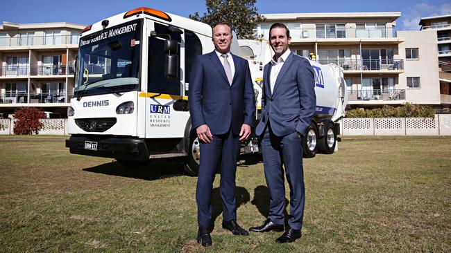 Anthony Johnston from URM and former Northern Beaches Council CEO Ben Taylor with the new garbage trucks. Picture: Adam Yip / Manly Daily