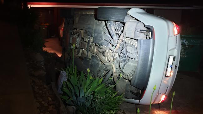 A man has fled after a bungled car theft that left a sedan tipped onto its side at Hillbank. Picture: SA Police