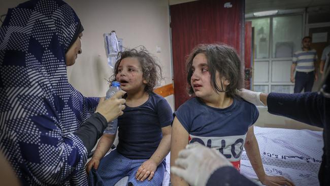 A Palestinian family arrives at Al-Shifa after intensive bombardments by Israeli forces on Gaza City at the weekend.