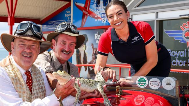 Birtles and the Bean in Darwin, NT at the Royal Flying Doctor Museum. Matthew Benns and Warren Brown, having arrived in Australia with their globetrotting car, with RFDS tourism manager (NT) Bek Garrett and Snowflake the baby saltwater crocodile. Photo: Nigel Wright