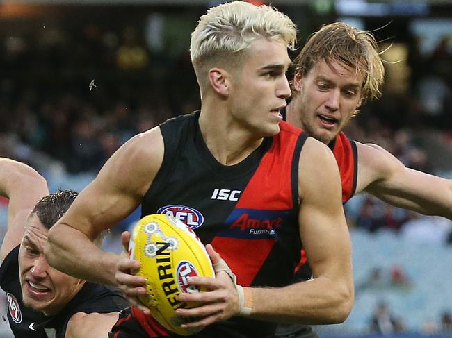 AFL Round 11. 02/06/2019.   Essendon v Carlton at the MCG.   Essendon's Matt Guelfi  gets away from Patrick Cripps of the Blues    . Pic: Michael Klein.