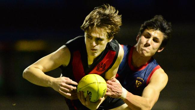 Rostrevor’s Oliver Piro is tackled by Trinity’s Joseph Fenwick at Norwood Oval. Picture: Michael Marschall