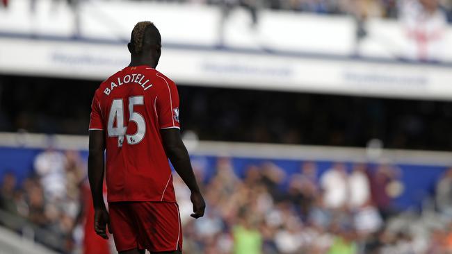 Liverpool's Italian striker Mario Balotelli reacts during the English Premier League football match between Queens Park Rangers and Liverpool at Loftus Road in London on October 19, 2014. Liverpool won the game 3-2. AFP PHOTO / ADRIAN DENNIS RESTRICTED TO EDITORIAL USE. No use with unauthorized audio, video, data, fixture lists, club/league logos or “live” services. Online in-match use limited to 45 images, no video emulation. No use in betting, games or single club/league/player publications.