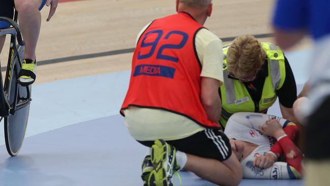 Stephanie Morton is helped by medical staff after crashing during the keirin final.