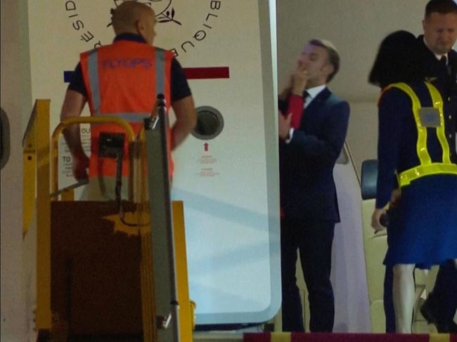 In this grab taken from video, France's President Emmanuel Macron prepares to disembark a plane on arrival in Vietnam, Sunday. Picture: Hau Dinh