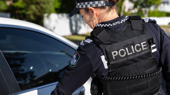 A 23-year-old woman has been charged with a string of offences after she allegedly armed herself and drove a car with two children inside directly at police before crashing.