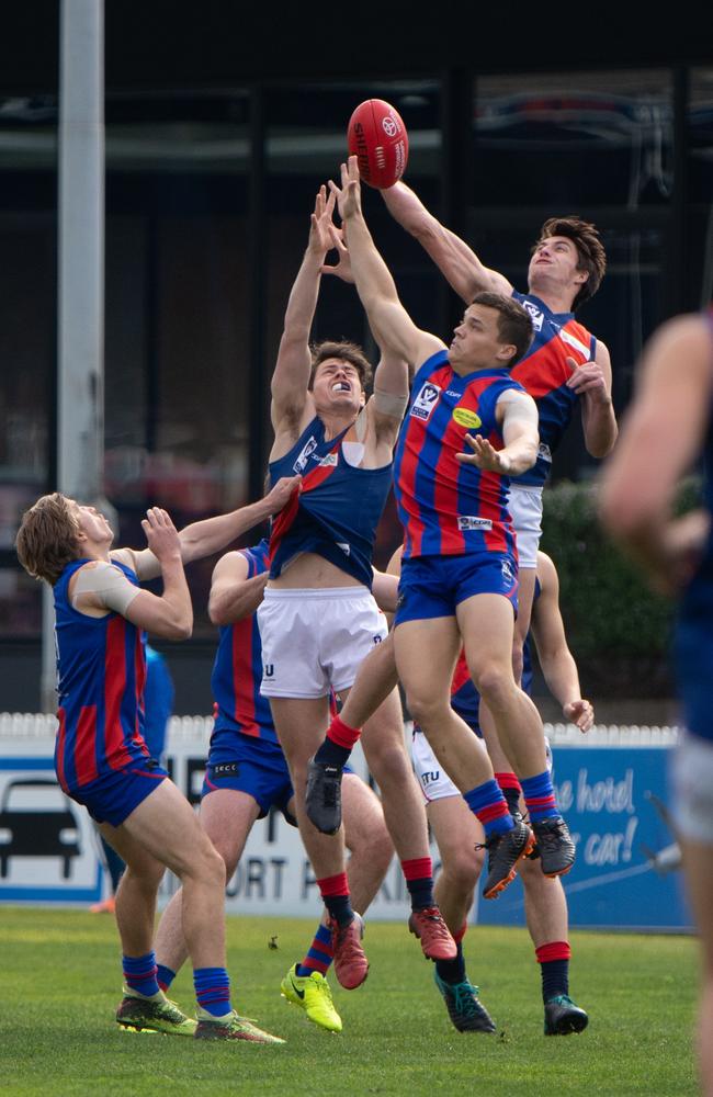 Lochie Dickson climbs over a pack to spoil against Port Melbourne.