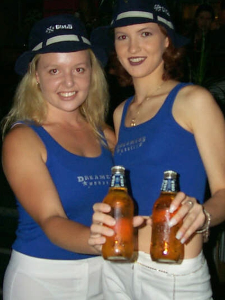 Trudie White and Lauren Bell handing out the complimentary beer at Rattle N Hum Nightclub, Mackay, 2001.