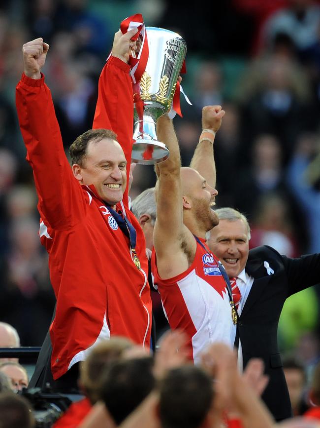 Longmire and Jarrad McVeigh hoist the premiership cup in 2012.