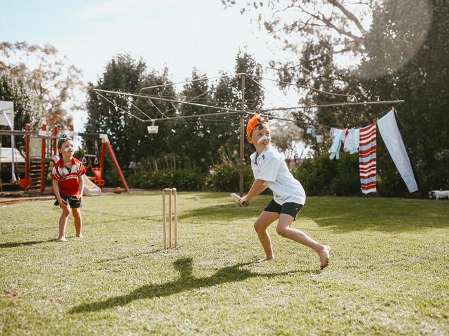 Bede & Flynn Redden playing backyard cricket. Picture: Clancy Paine