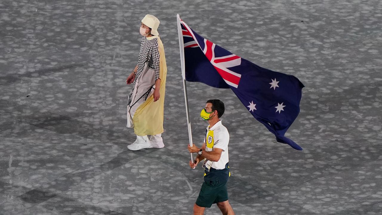 Australian Gold medalist Mat Belcher carries the Australian Flag during the Closing Ceremony. (AAP Image/Joe Giddens)