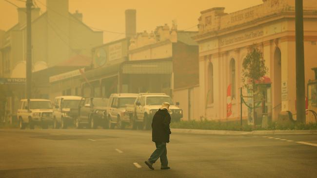Smoke is heavy and visibility low down the main street of Orbost in fire ravaged East Gippsland. Picture: Mark Stewart