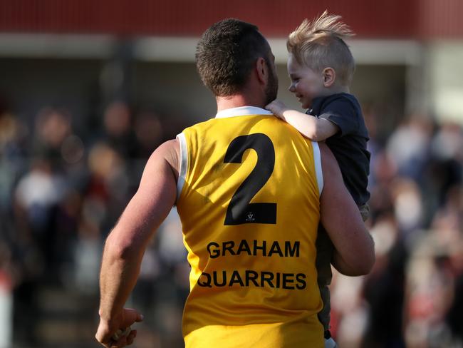 Well done, Dad! Best-on-ground Byron Barry with his number one fan. Picture: Mark Dadswell