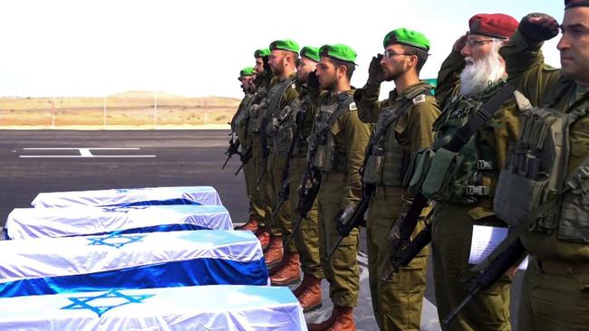 Israeli soldiers salute the coffins of dead hostages after they were handed over by Hamas terrorists in the Gaza Strip on Thursday.