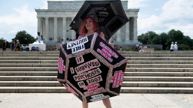 Melanie Carlson holds up umbrellas decorated with her message during a rally in front of the Lincoln Memorial protesting the conservatorship of Britney Spears in Washington, DC.Picture: AFP