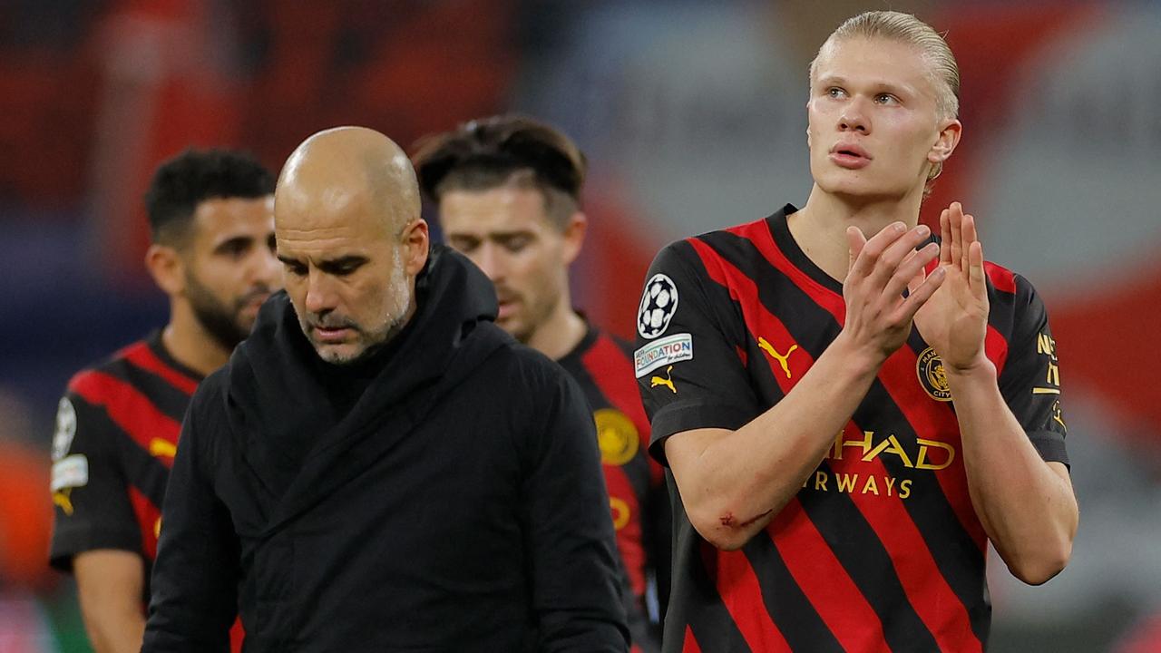 Manchester City's Spanish manager Pep Guardiola (L) and Manchester City's Norwegian striker Erling Haaland after the match.