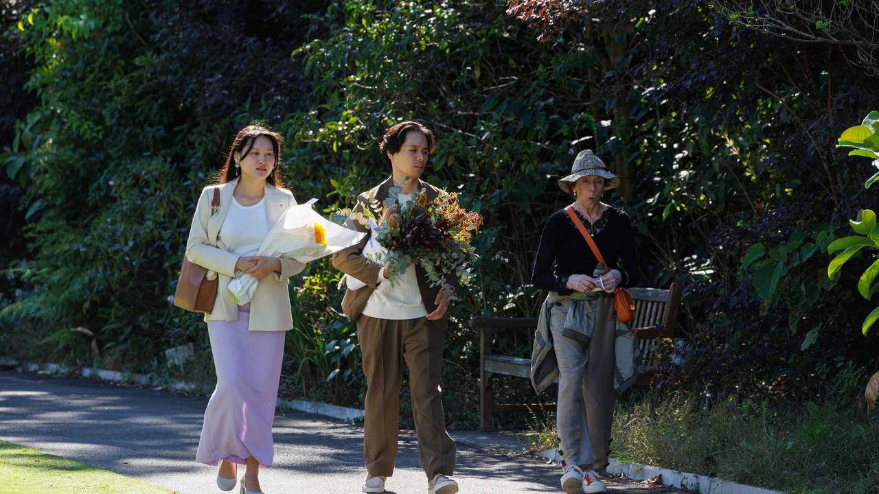 Loved ones carry bouquets to the service. Picture: NCA NewsWire / David Swift