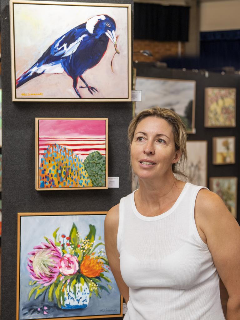 Grammar Art Show president Rebecca Statton with works by the feature artist, Mel Simmonds. Picture: Nev Madsen.