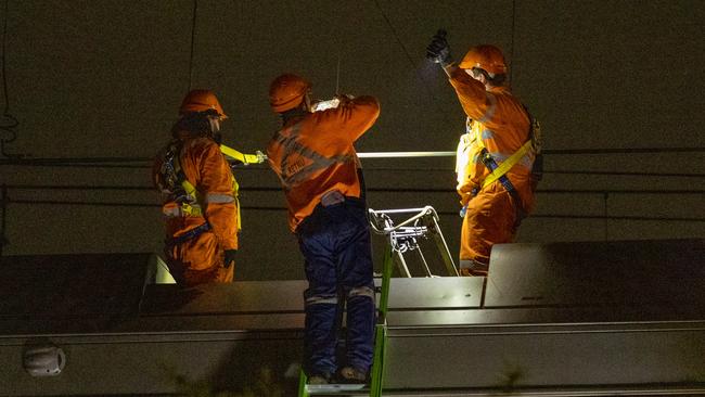 Crews work at Homebush to cut the entangled train away on Tuesday night. Picture: Thomas Lisson