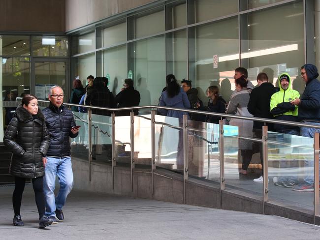 People are seen queuing up outside the Passport Office in Sydney on 28 June, 2022. Picture: Gaye Gerard