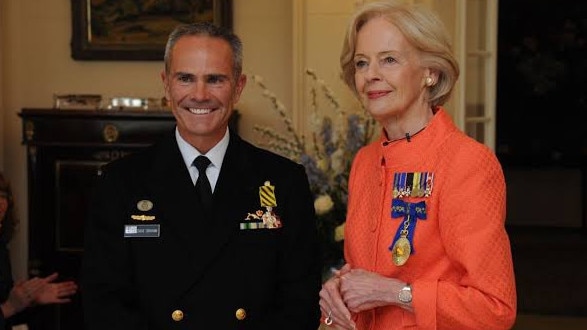 David Graham (left) a top former naval officer, has been found guilty of a string of child sex offences. He is pictured being presented with the Conspicuous Service Cross. PICTURE: Royal Australian Navy/Supplied