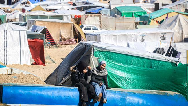 Children sit near tents at a makeshift shelter for Palestinians who fled to Rafah in the southern Gaza Strip. Picture: AFP