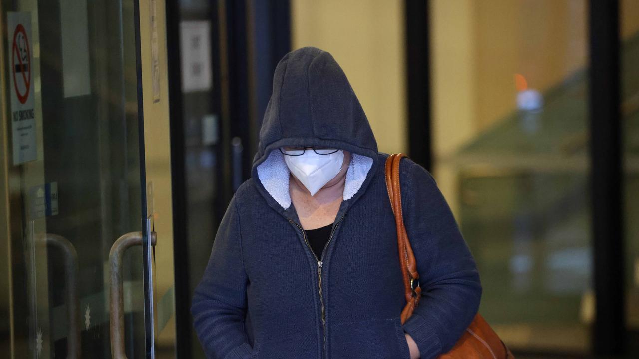 The Sydney grandmother turned around to put on a hoodie and a Covid-19 mask after spotting reporters outside. She did not respond when asked for comment. Picture: NCA NewsWire / Damian Shaw