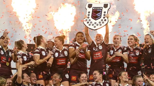 TOWNSVILLE, AUSTRALIA - JUNE 27:  Maroons players celebrate with the Women's State of Origin shield after winning game three of the 2024 Women's State of Origin series between Queensland Maroons and New South Wales Sky Blues at Queensland Country Bank Stadium on June 27, 2024 in Townsville, Australia. (Photo by Ian Hitchcock/Getty Images)