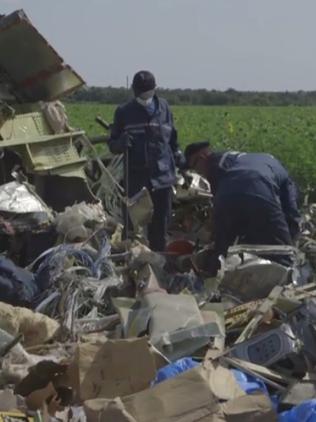 An angle grinder is used to cut up the wreckage.