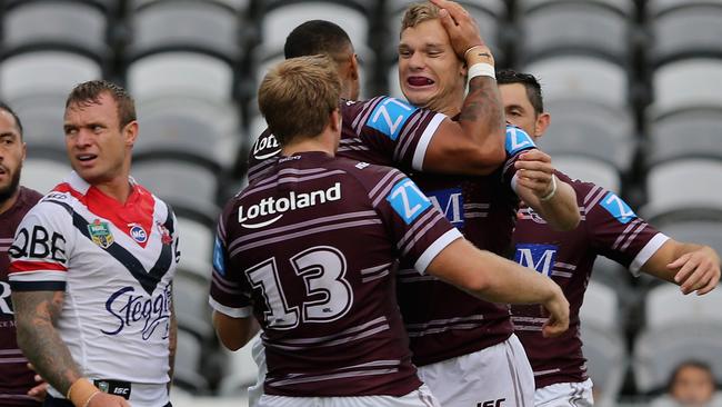 GOSFORD, AUSTRALIA — FEBRUARY 18: Tom Trbojevic of the Sea Eagles celebrates a try with his team with Jake Friend of the Roosters looking dejected during the NRL Trial match between the Manly Warringah Sea Eagles and Sydney Roosters at Central Coast Stadium on February 18, 2017 in Gosford, Australia. (Photo by Ashley Feder/Getty Images)