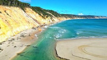 An image shared by the Tin Can Bay Coast Guard reveals how close the tip of the sand mass had moved to the shoreline.