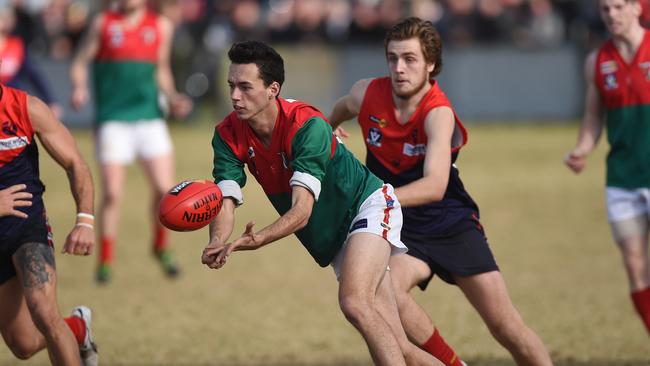 Pines young gun Patrick Jackson fires out a handball against Mt Eliza at Madsen Reserve on Saturday. Picture: Chris Eastman