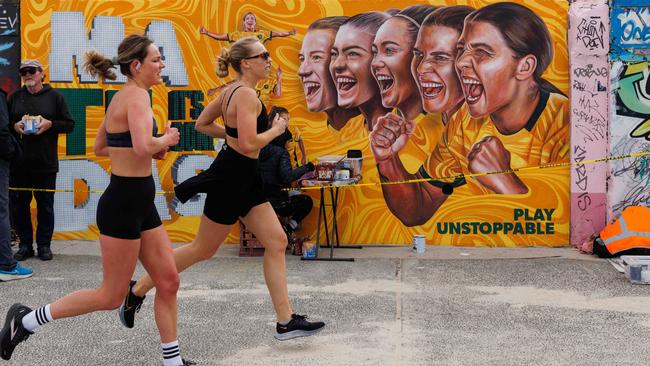 Melbourne Artist Danielle Weber paints a mural of the Matildas on the the Bondi Beach front walk. Picture: NCA NewsWire / David Swift