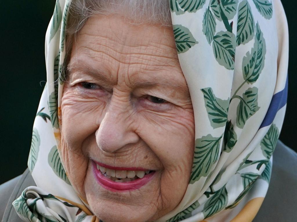 (FILES) In this file photo taken on October 1, 2021 Britain's Queen Elizabeth II gestures on her arrival at the Balmoral Cricket Pavilion to plant a tree with Britain's Prince Charles, Prince of Wales to mark the start of the official planting season for the Queen's Green Canopy (QGC) at Balmoral Estate in Scotland. - Britain's Queen Elizabeth II will take medical advice and rest for "at least" another two weeks, Buckingham Palace said Friday, having recently spent a night in hospital to undergo "preliminary examinations". (Photo by Andrew Milligan / POOL / AFP)