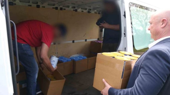 Police seize the infant formula tins. Picture: NSW Police