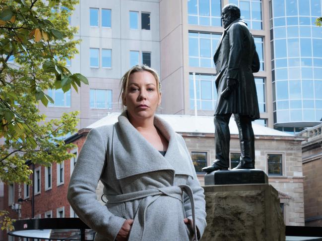 Tasmanian Aboriginal activist and campaign co-ordinator for the Tasmanian Aboriginal Centre with the contentious statue of one-time Tasmanian Premier and doctor William Crowther in Franklin Square. Picture: Peter Mathew