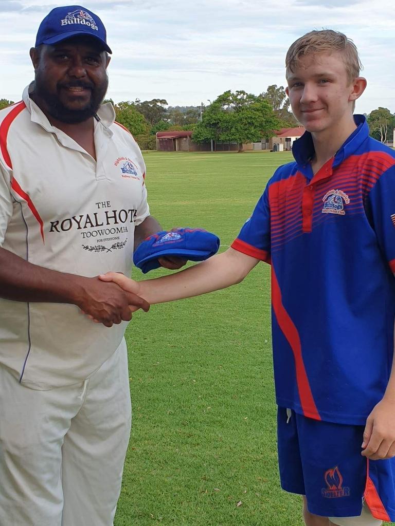 Kieren Gibbs (C) handin Josh Cranston his debut baggy cap. Contributed.