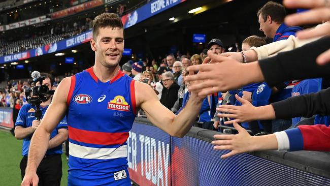 MELBOURNE, AUSTRALIA - MAY 01: Josh Dunkley of the Bulldogs high fives fans in his 100th game after winning the round seven AFL match between the Western Bulldogs and the Essendon Bombers at Marvel Stadium on May 01, 2022 in Melbourne, Australia. (Photo by Quinn Rooney/Getty Images)