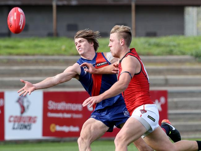 Nathan Blair pushes the ball clear of Essendon’s Josh Begley while playing for Coburg. Picture: Mark Wilson