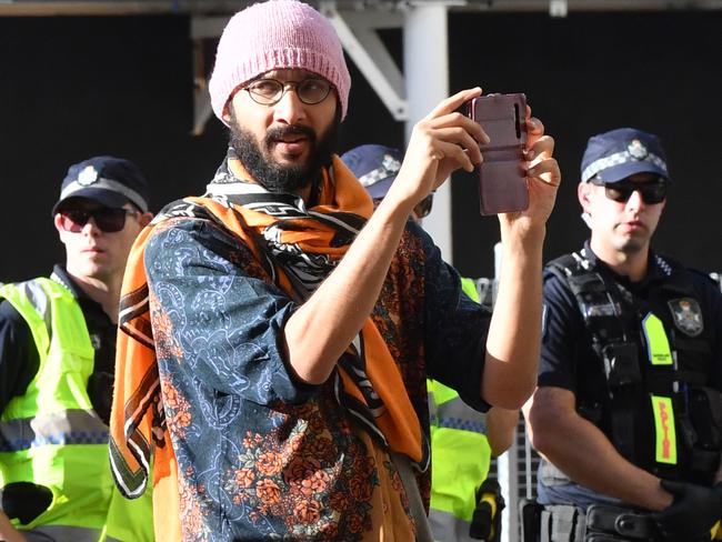 Brisbane City Council councillor Jonathan Sri (centre) is seen during a Black Lives Matter protest outside the Roma Street Magistrates Court in Brisbane, Wednesday, June 17, 2020. (AAP Image/Darren England) NO ARCHIVING