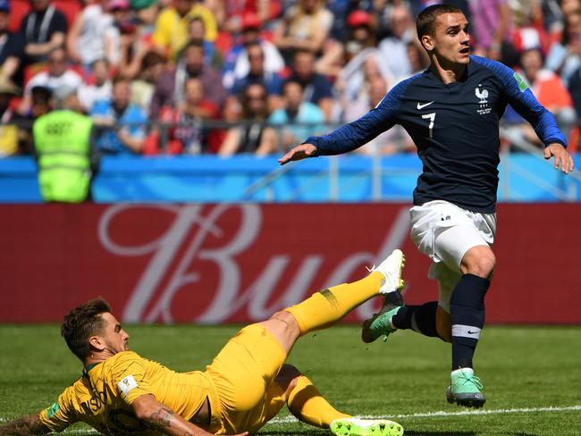 Australia's Josh Risdon slides in to tackle Antoine Griezmann. Pic: AAP