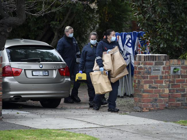 Police remove items from a Brighton home. Picture: Andrew Henshaw