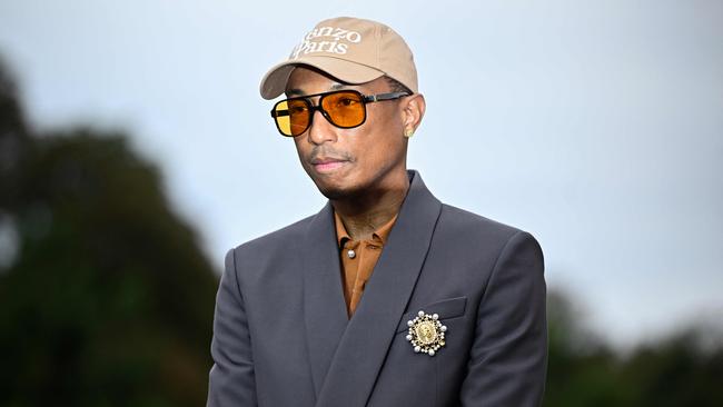 US rapper, artist and fashion designer Pharrell Williams poses on the red carpet for 'The Prelude to the Olympics'. (Photo by JULIEN DE ROSA / AFP)