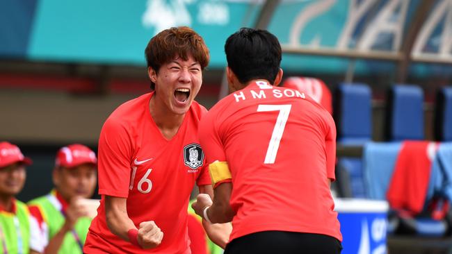 South Korea's Hwang Ui Jo (L) celebrates with a teammate Son Heung Min after scoring a goal against Uzbekistan