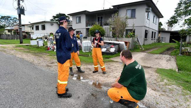 Wednesday February 13. Heavy rain causes flooding in North Queensland. Clean up after flooding in Ingham. Rural firefighters from Rupertswood and Black River take a break after cleaning out a block of units. Picture: Evan Morgan