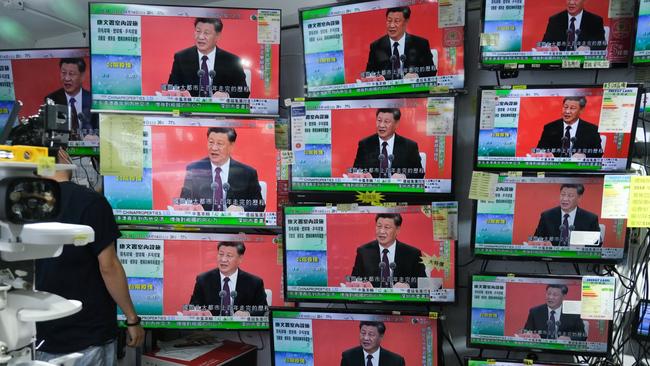 A news report on a speech by Chinese President Xi Jinping in the city of Shenzhen is shown on television screens in a shop in Hong Kong. Picture: Bloomberg