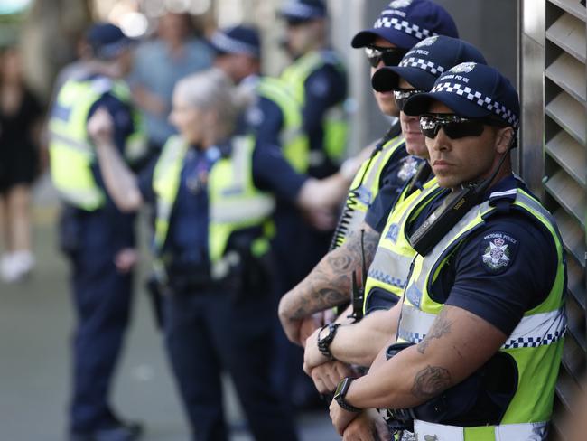 Police wait outside the custody centre at Melbourne Magistrates’ Court. Picture: David Caird