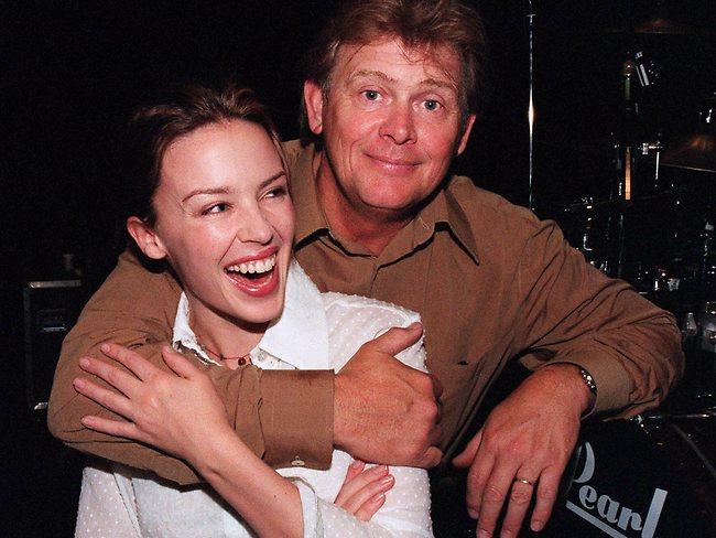 The East Timor concert for Australian troops. Kylie Minogue is hugged by John Farnham while rehearsing for the concert in December 1999. Picture: File